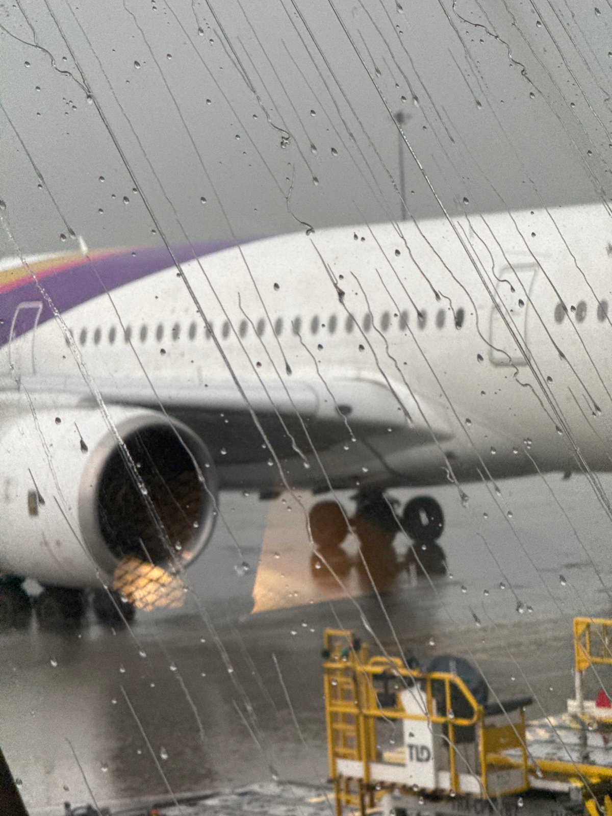 Rainy layover at Suvarnabhumi, planes on the tarmac