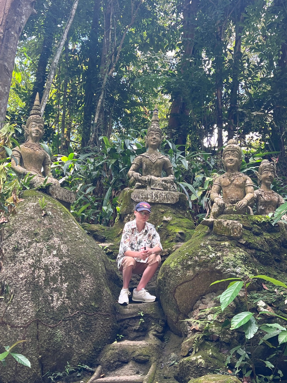 Tourist documents ancient jungle temple ruins in Ko Samui