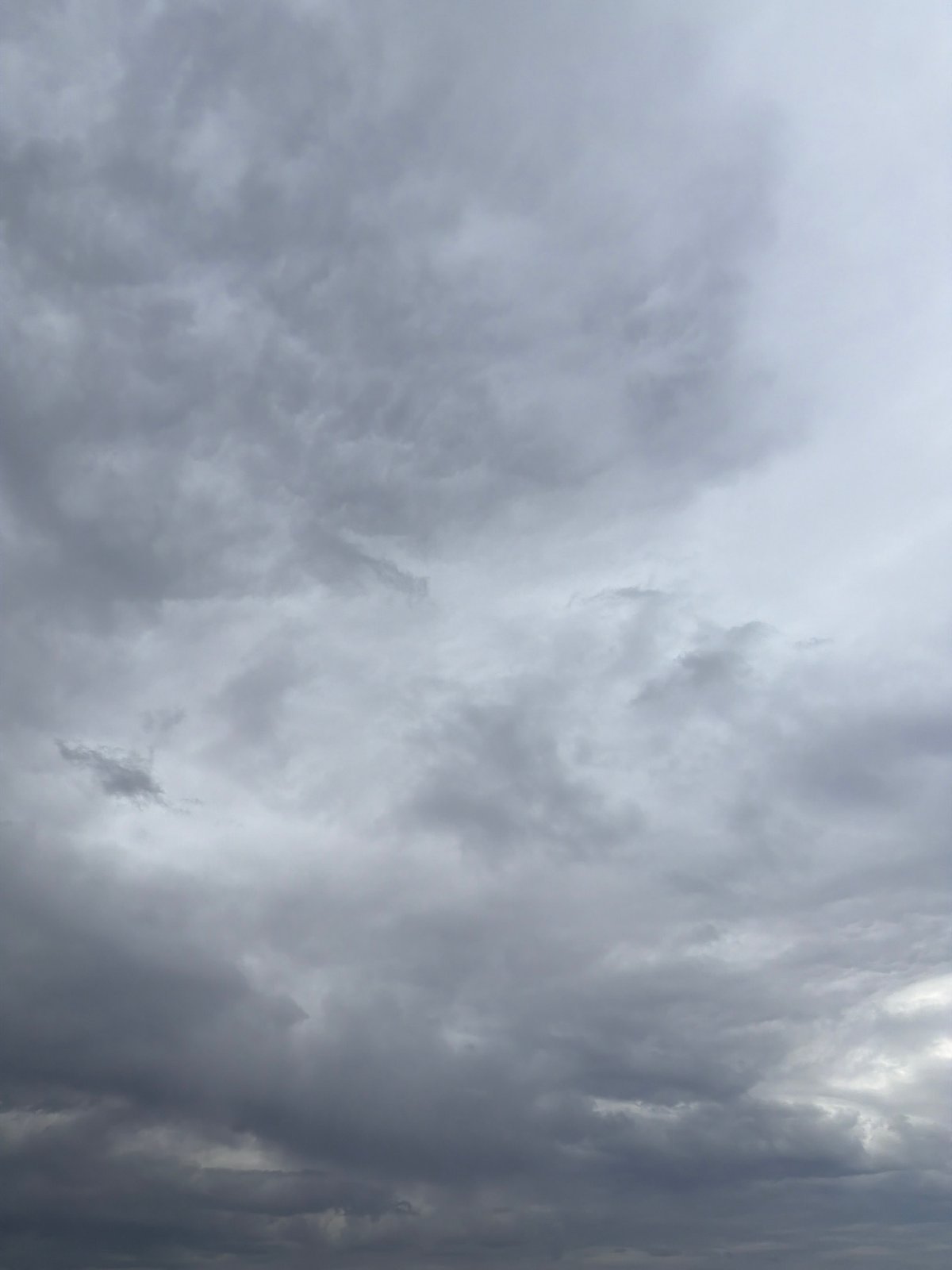 Man fishes Kama River under cloudy skies in Chaikovsky