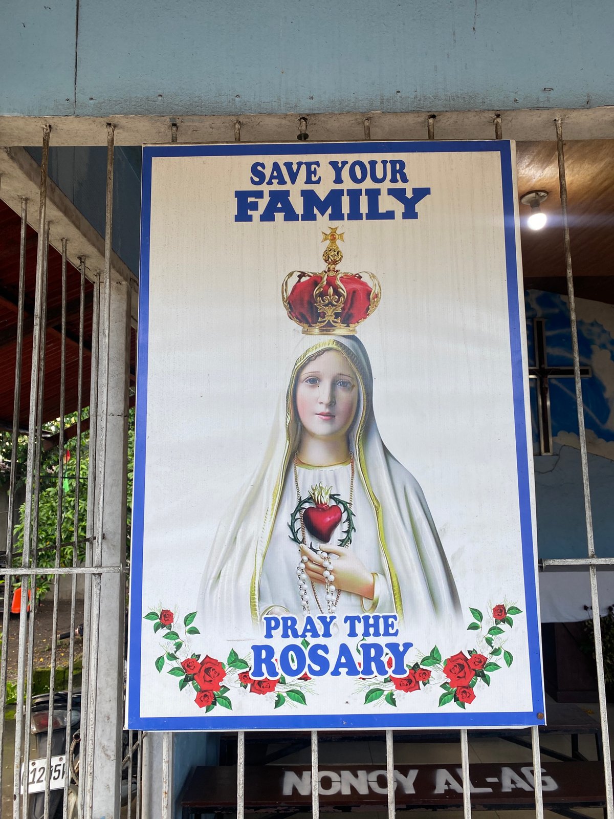 Davao City roadside: street traffic, storefronts, and a roadside shrine