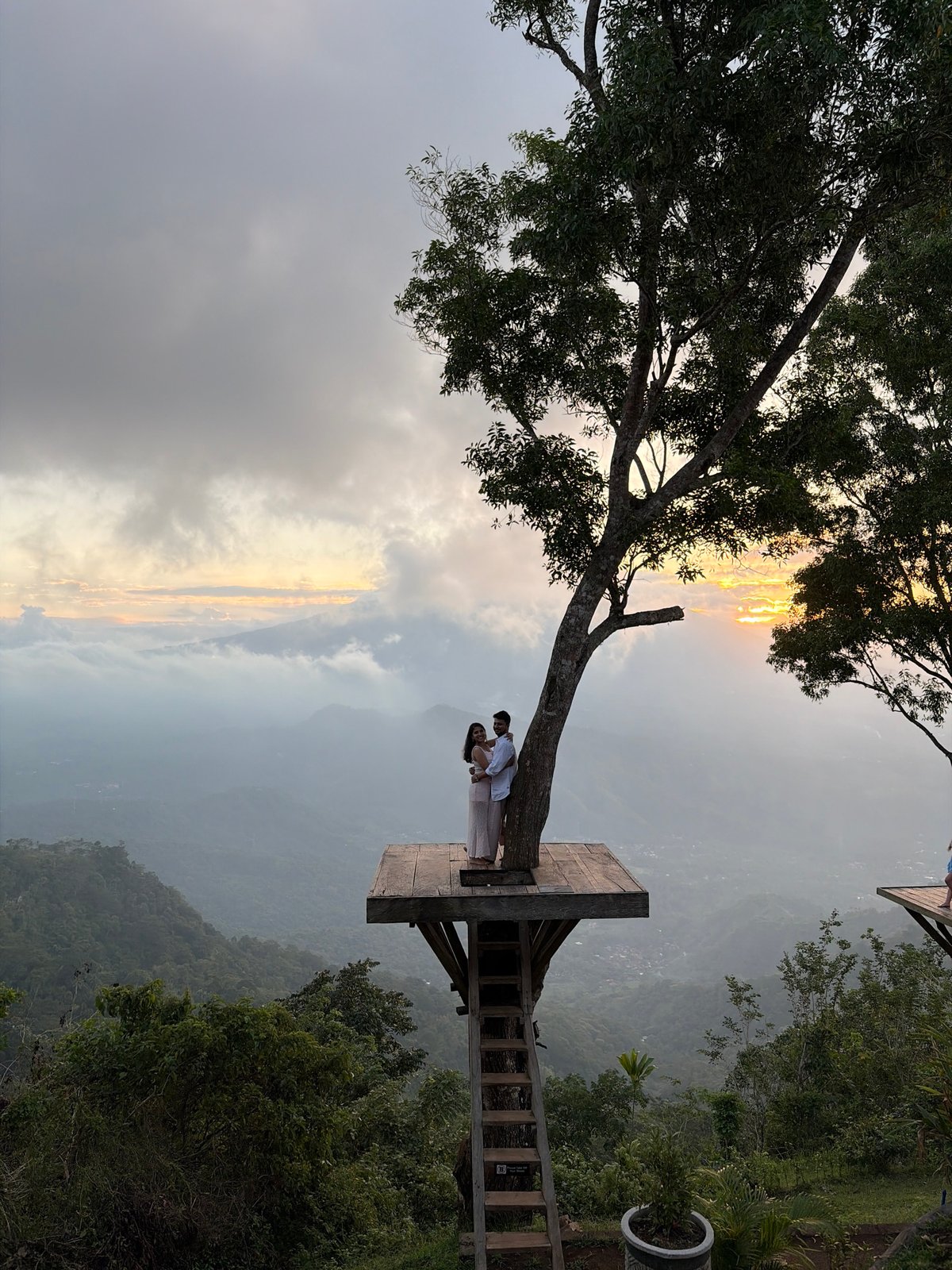 Treetop platform overlooks misty mountains in Abang, Indonesia