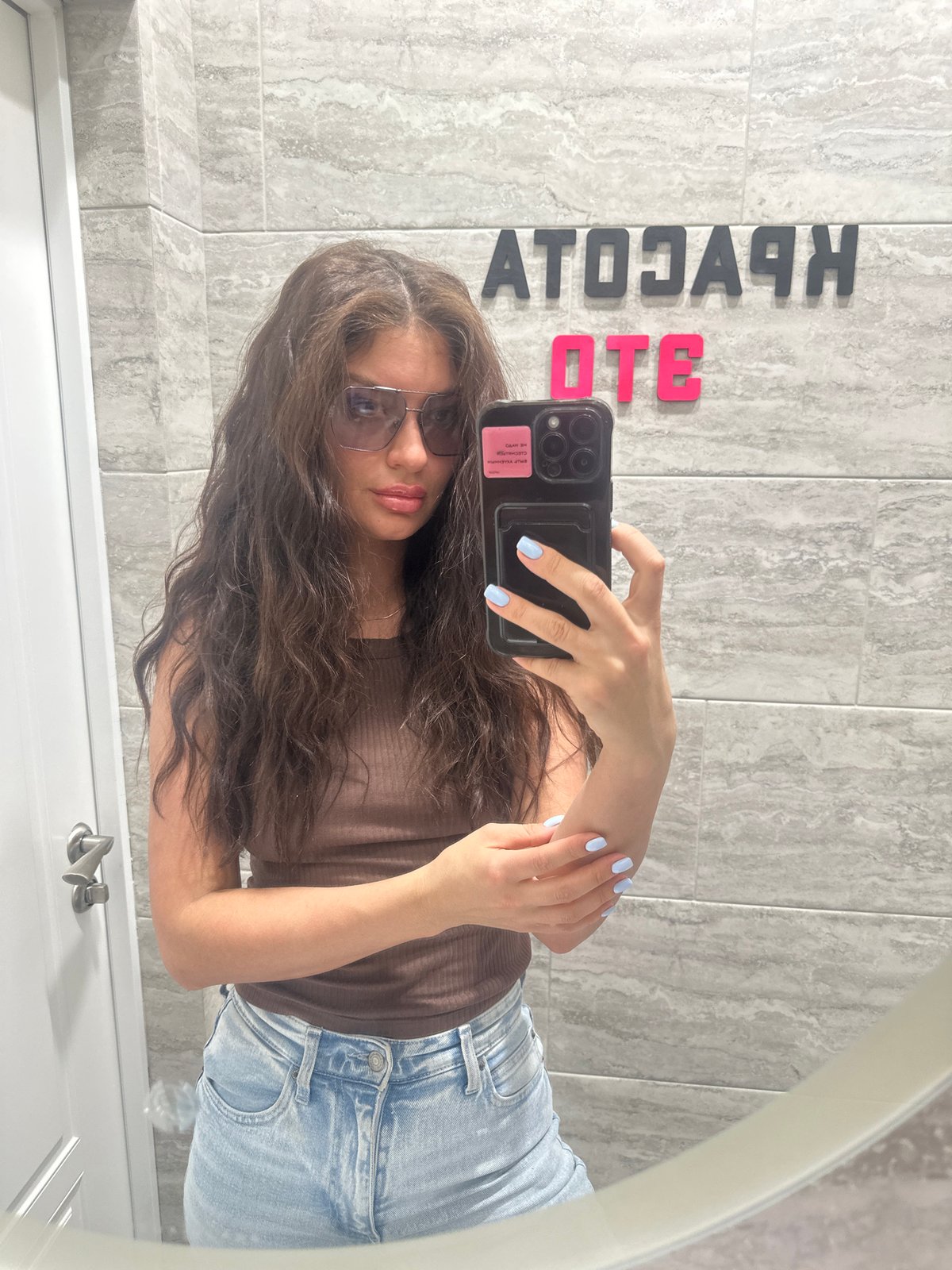 Woman takes bathroom mirror selfie in Moscow