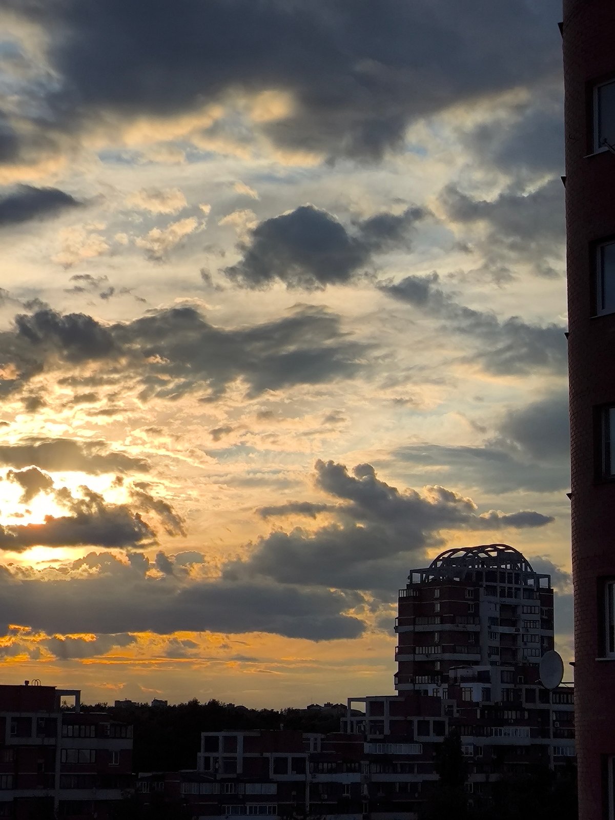 Dramatic sunset captured over urban landscape in sequential photos