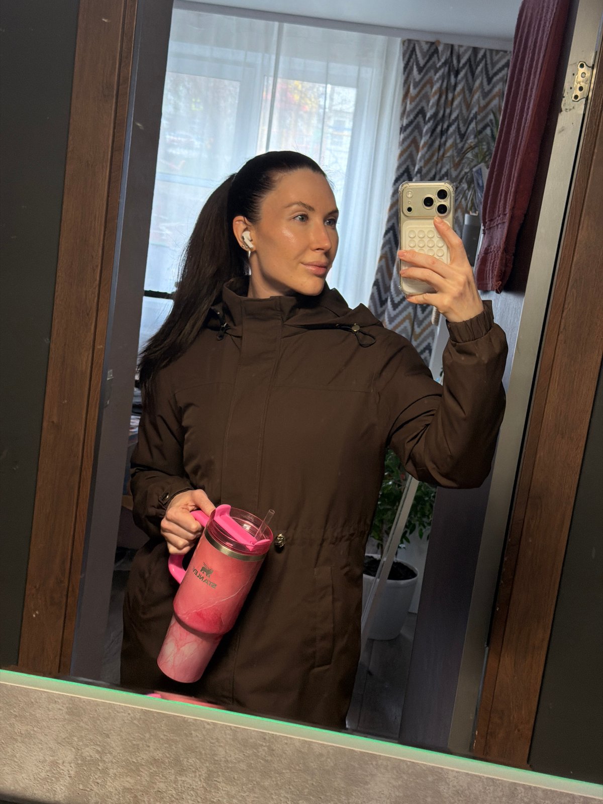 Woman takes mirror selfie indoors in Perm, Russia