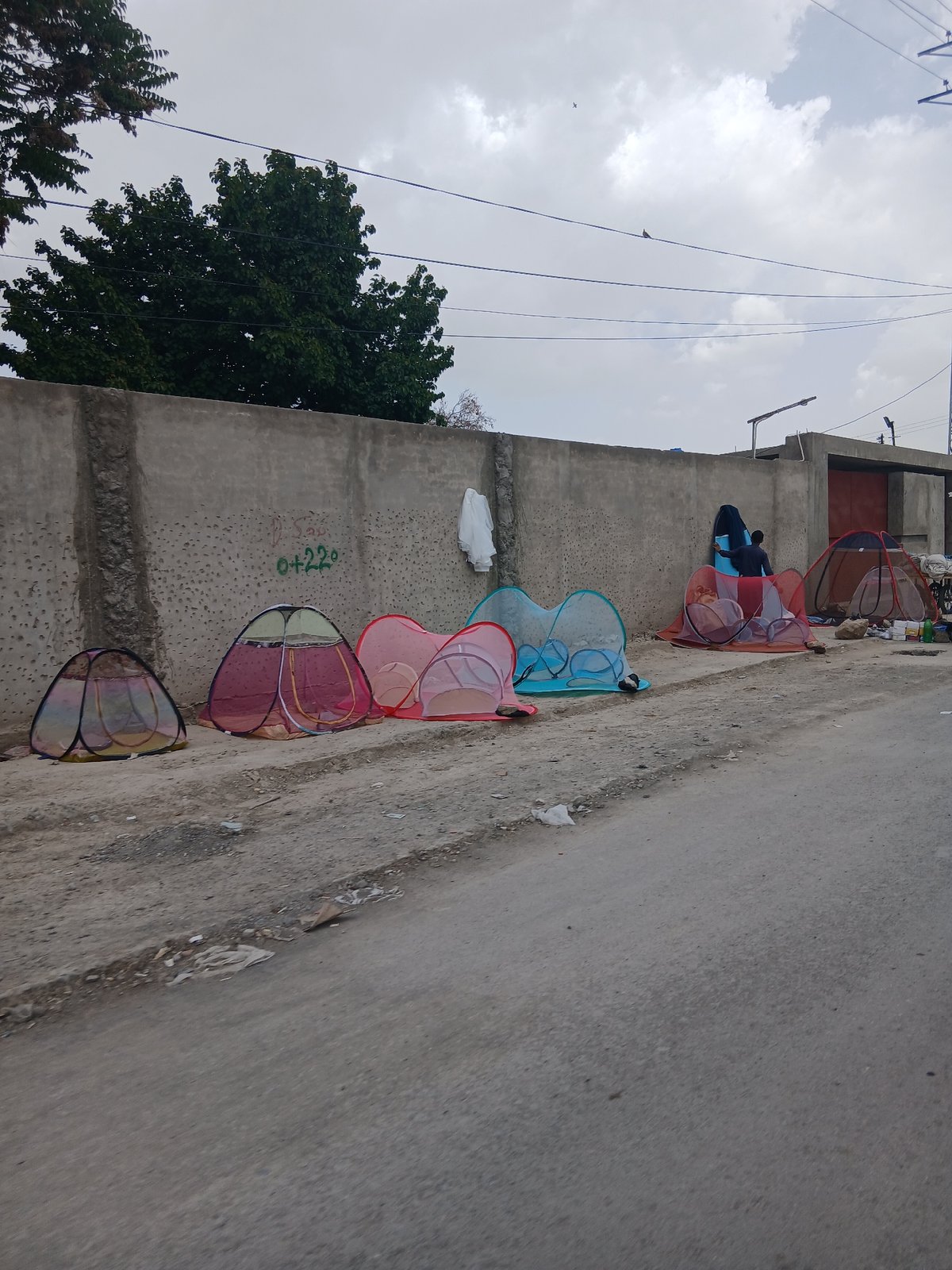 Colorful temporary shelters spotted along wall in Quetta