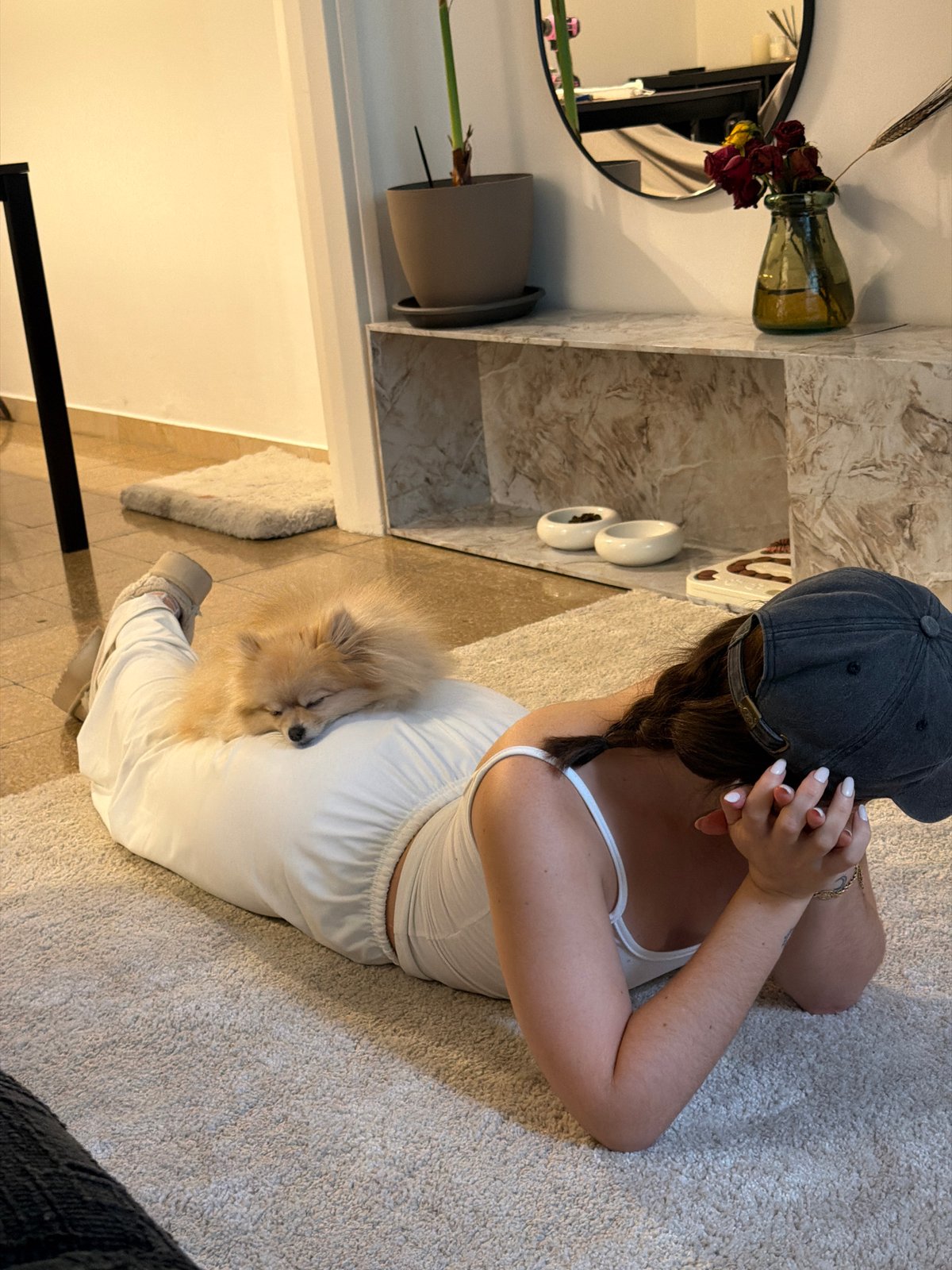 Woman practices yoga with Pomeranian companion in Barcelona home