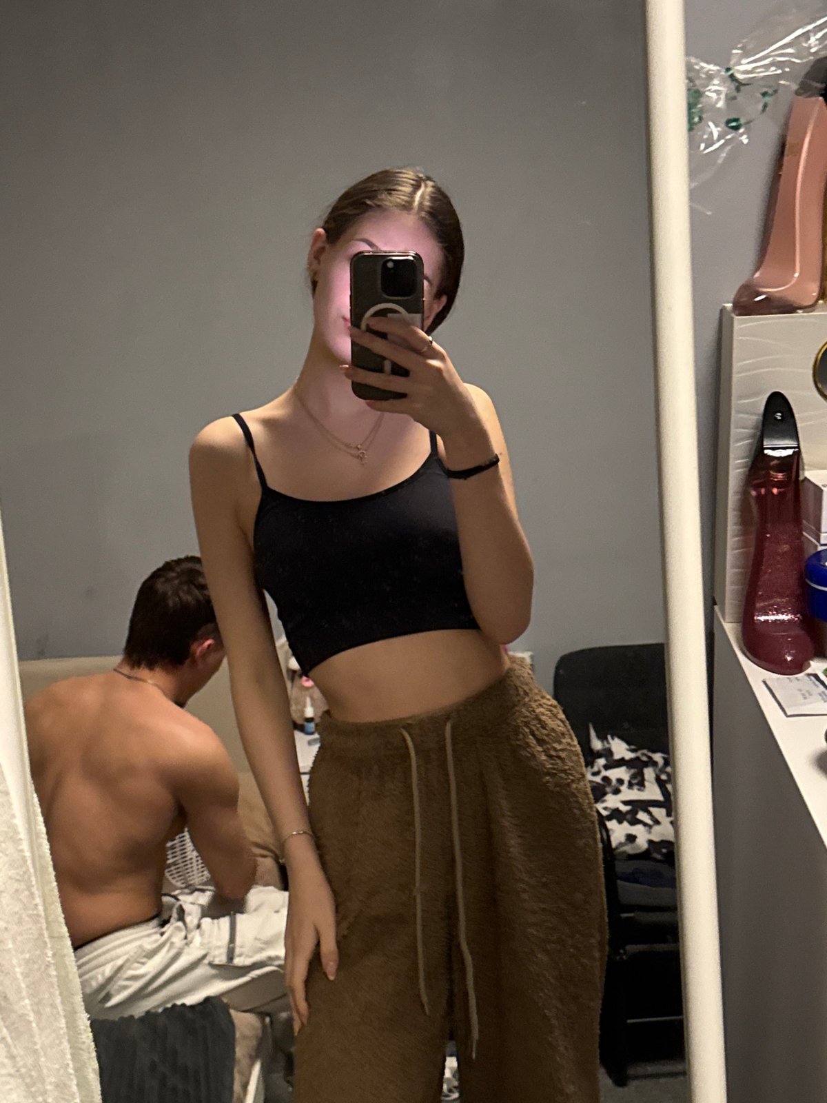 Woman takes mirror selfies in bedroom in Sofia
