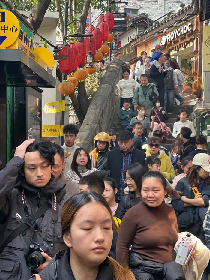 Early morning crowds gather for street food in Chongqing district