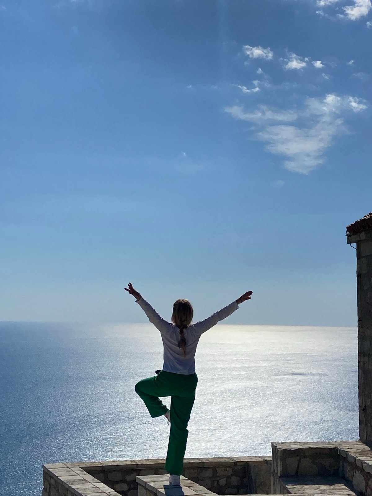 Person poses for photo at Kamenovo coastline, Montenegro