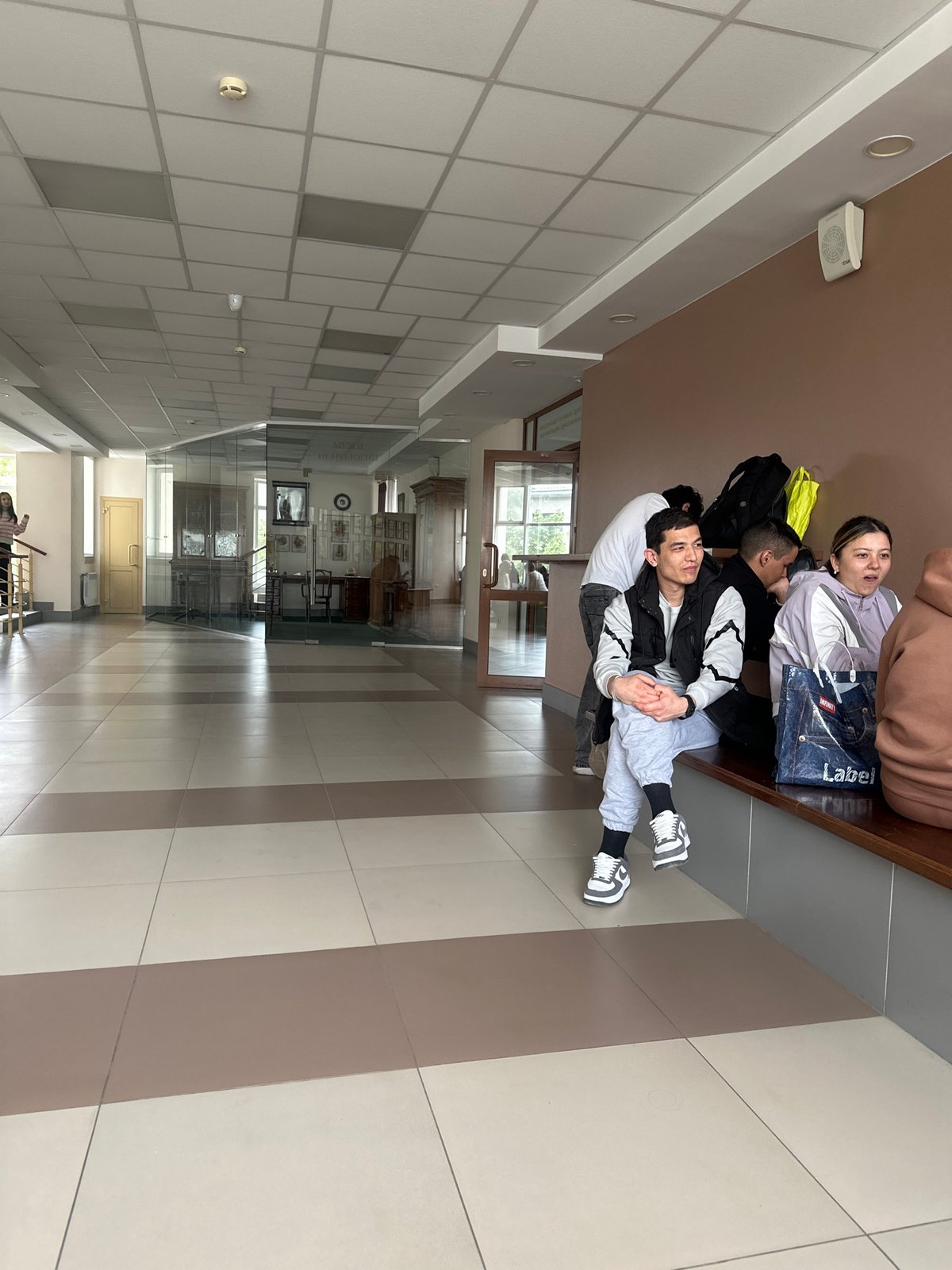 Young people rest in Kazan institutional hallway