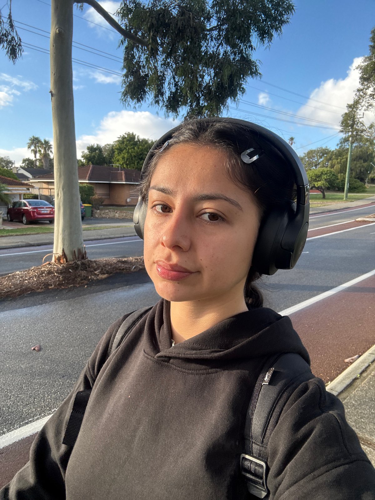 Woman takes evening selfies while walking in Calista suburb