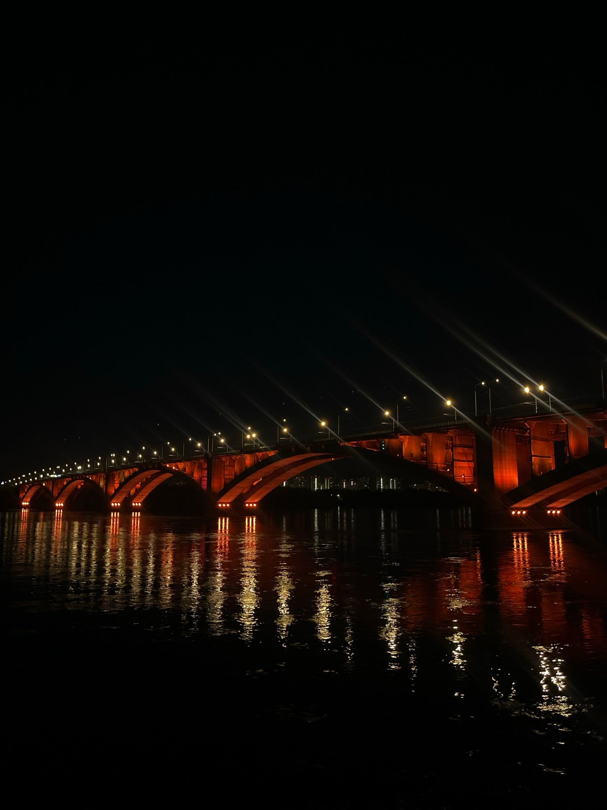 Illuminated bridge observed at night in Krasnoyarsk, Russia
