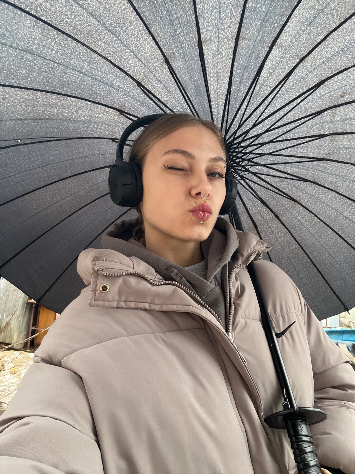 Woman poses playfully with umbrella in early morning Russia