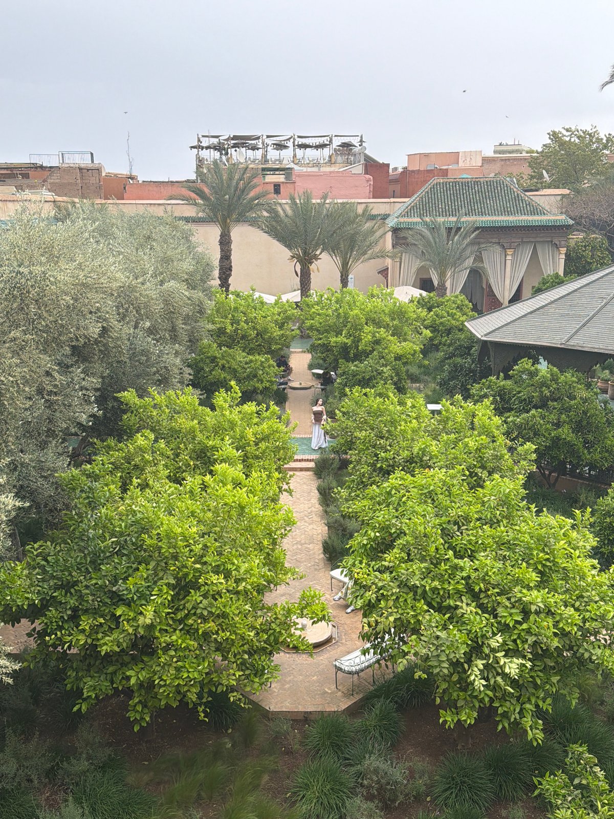 Visitor captures garden views and tile details at Marrakesh attraction