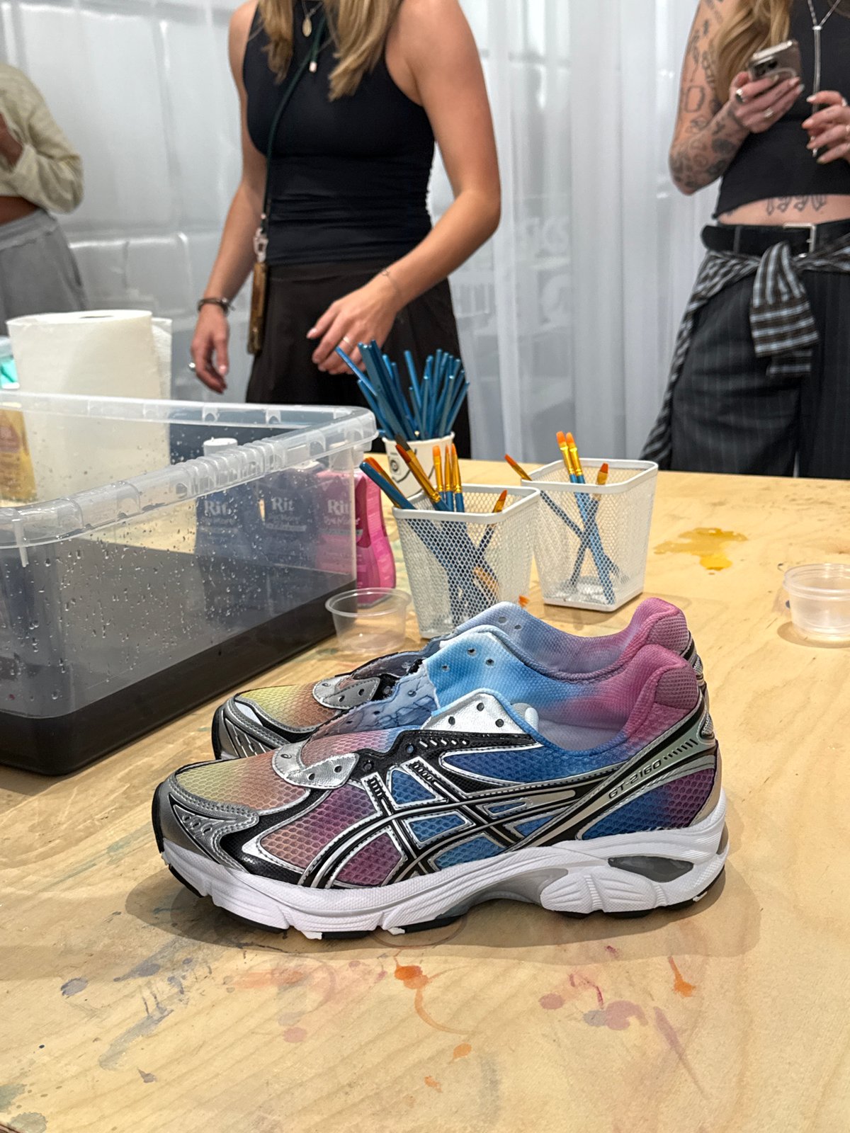 Women customize sneakers with gradient dyes in London craft session