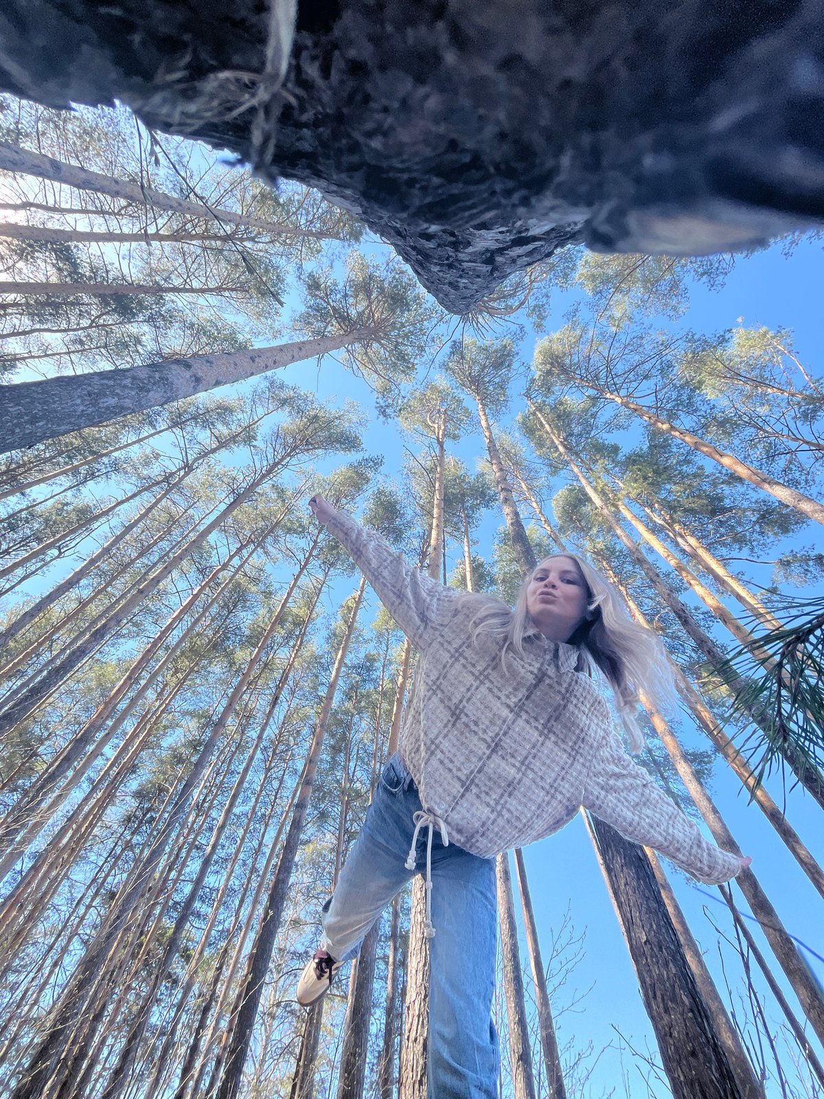 Woman photographed with outstretched arms in Chaikovsky forest