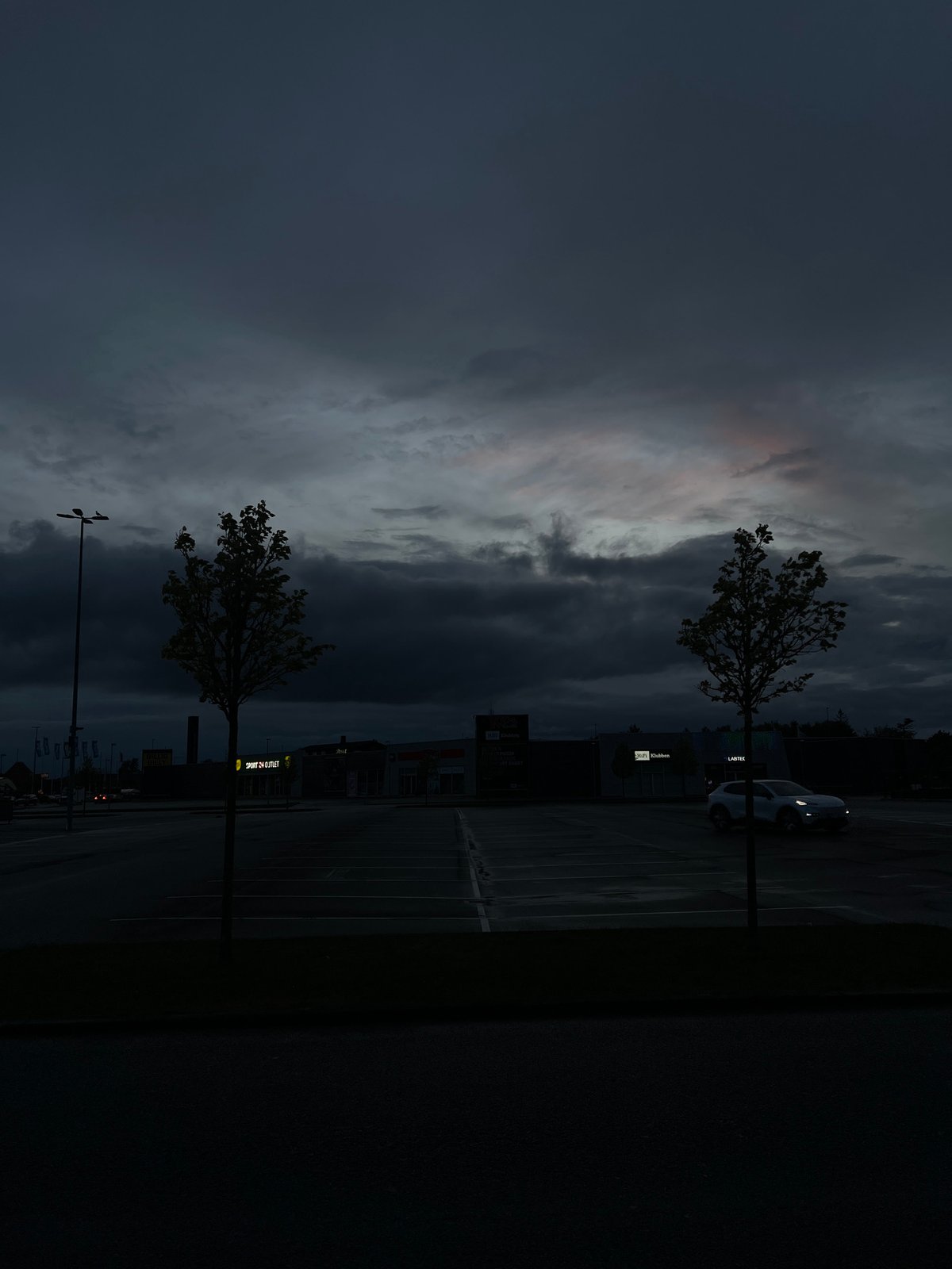 Dramatic cloud formations observed over Aalborg parking lot at dusk