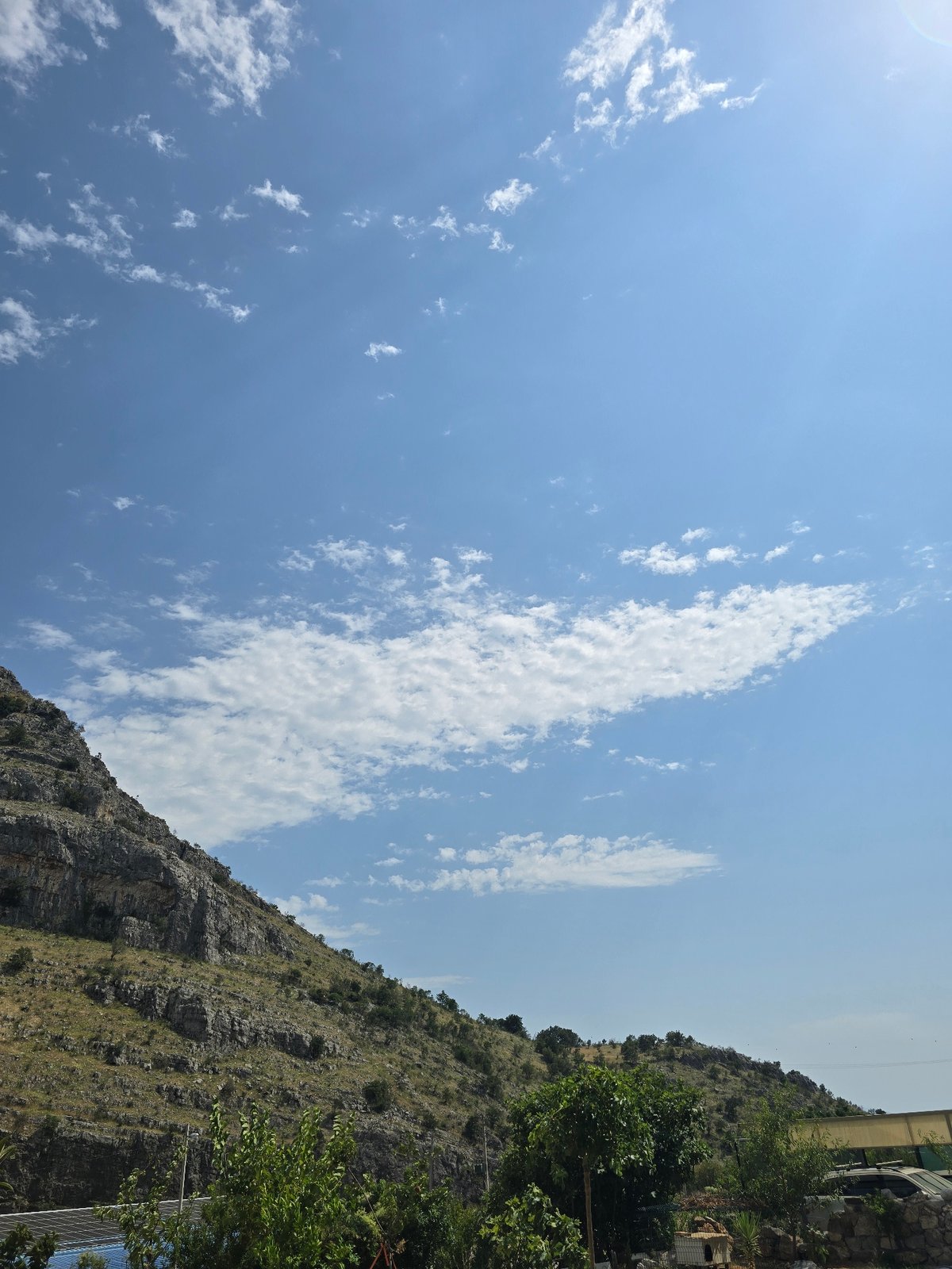 Rocky mountain views from below, plus a resting puppy nearby.
