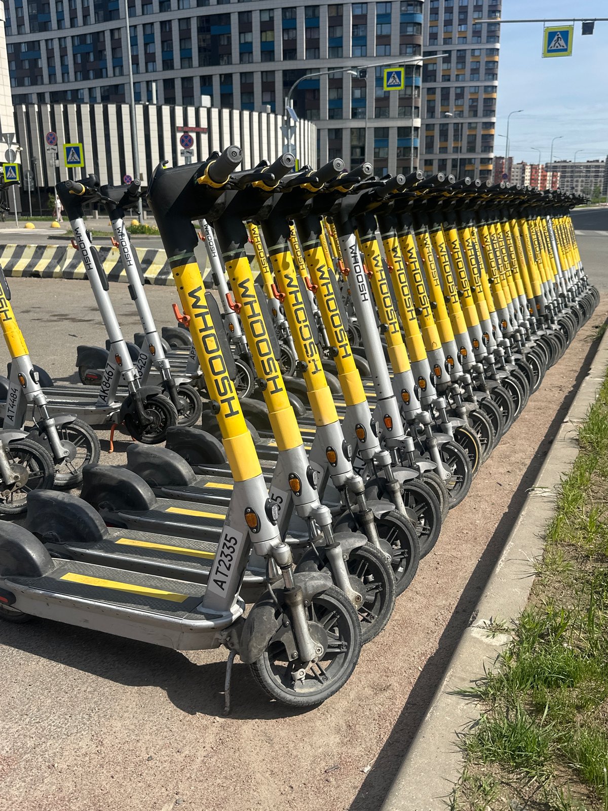 Electric scooters parked in orderly row in Murino, Russia
