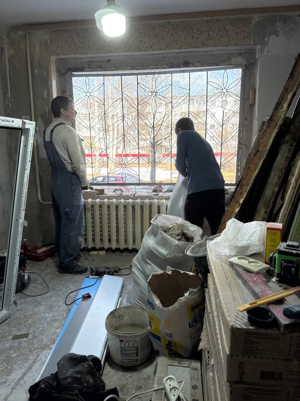 Window installers work on apartment renovation in Chaikovsky, Russia