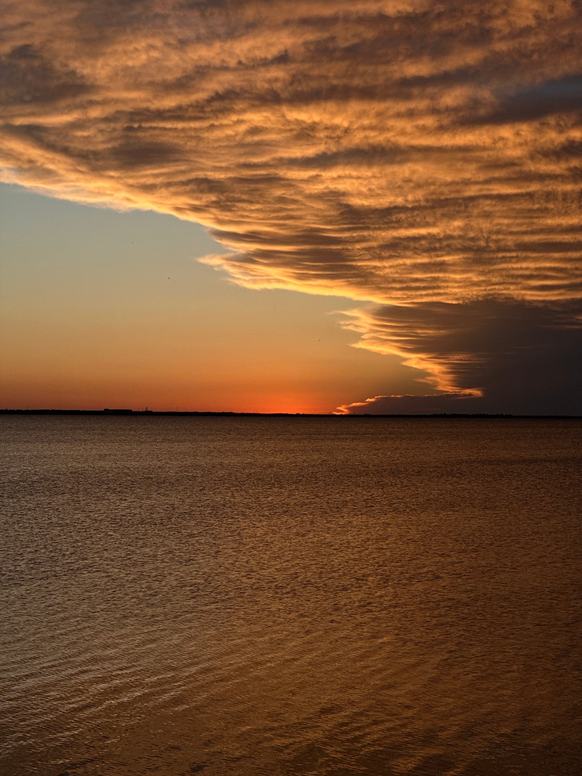 Sunset observed over calm waters in Kokshetau, Kazakhstan