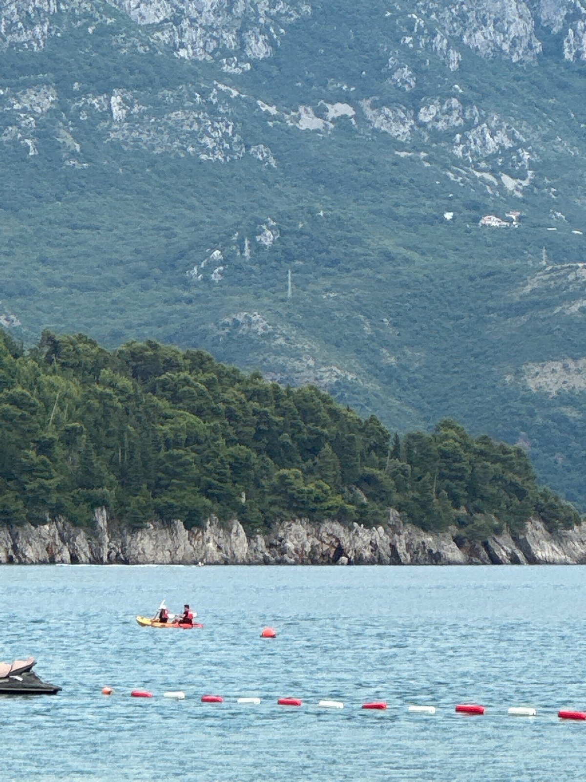 Summer afternoon parasailing and beach activities in Budva, Montenegro