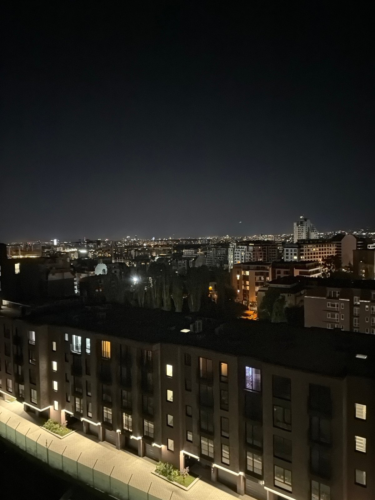 Sofia's nighttime skyline glowing across a dense urban grid