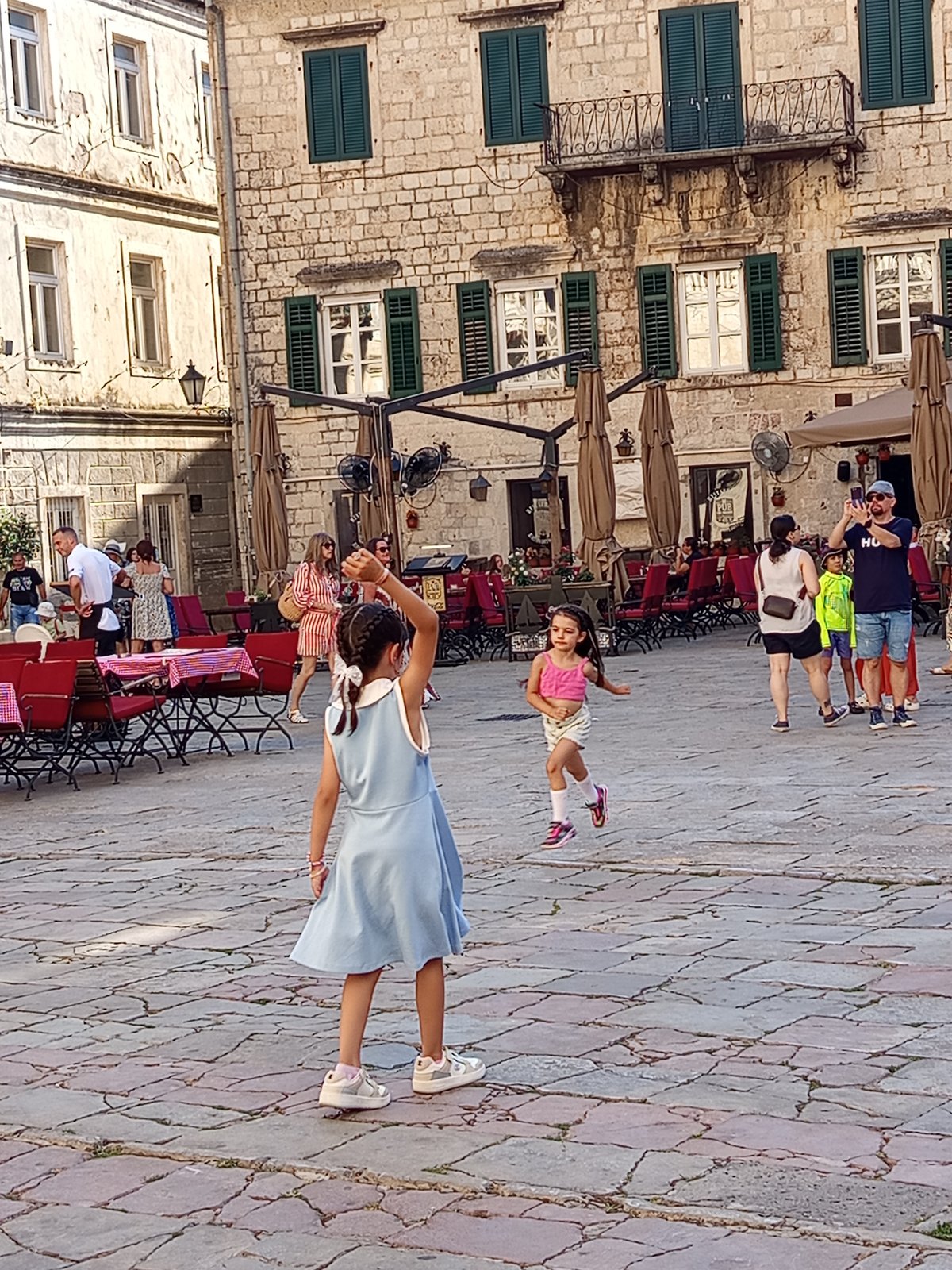 Kotor's old town square buzzing on a sunny afternoon