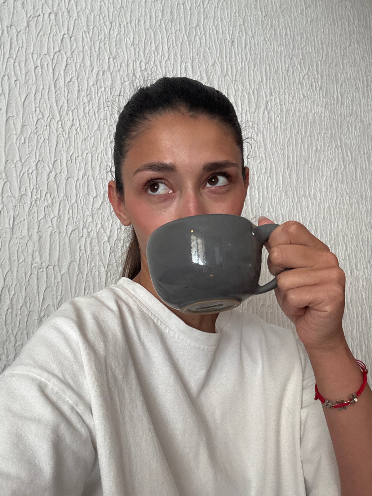 Woman drinks coffee at home in Sutomore, Montenegro