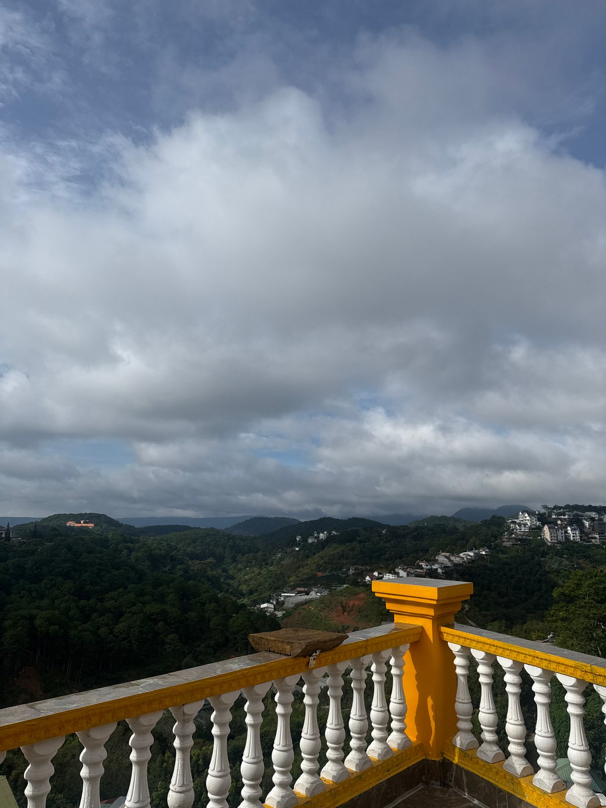 Balcony yoga session overlooking Da Lat's hilly valley