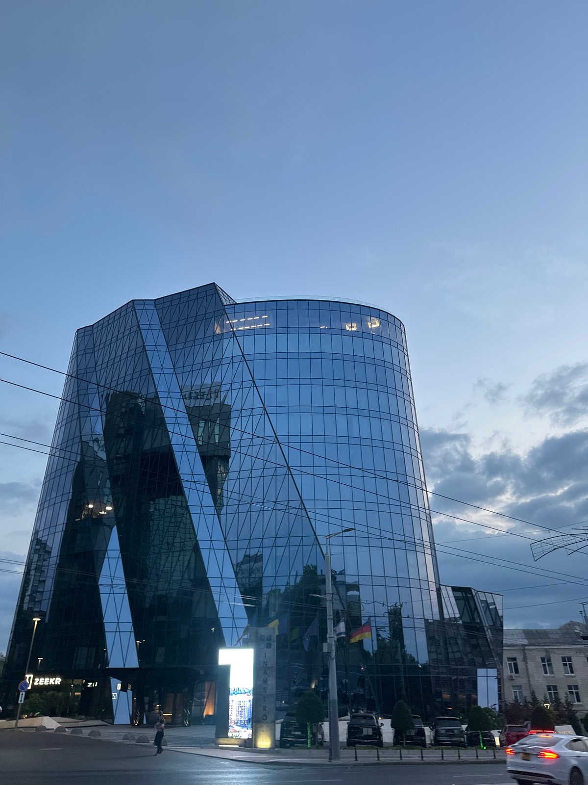 Dusk settles over a glass skyscraper in central Chișinău