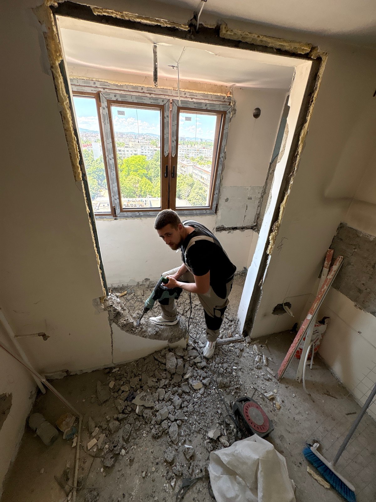 Man conducts demolition work with jackhammer in Sofia building