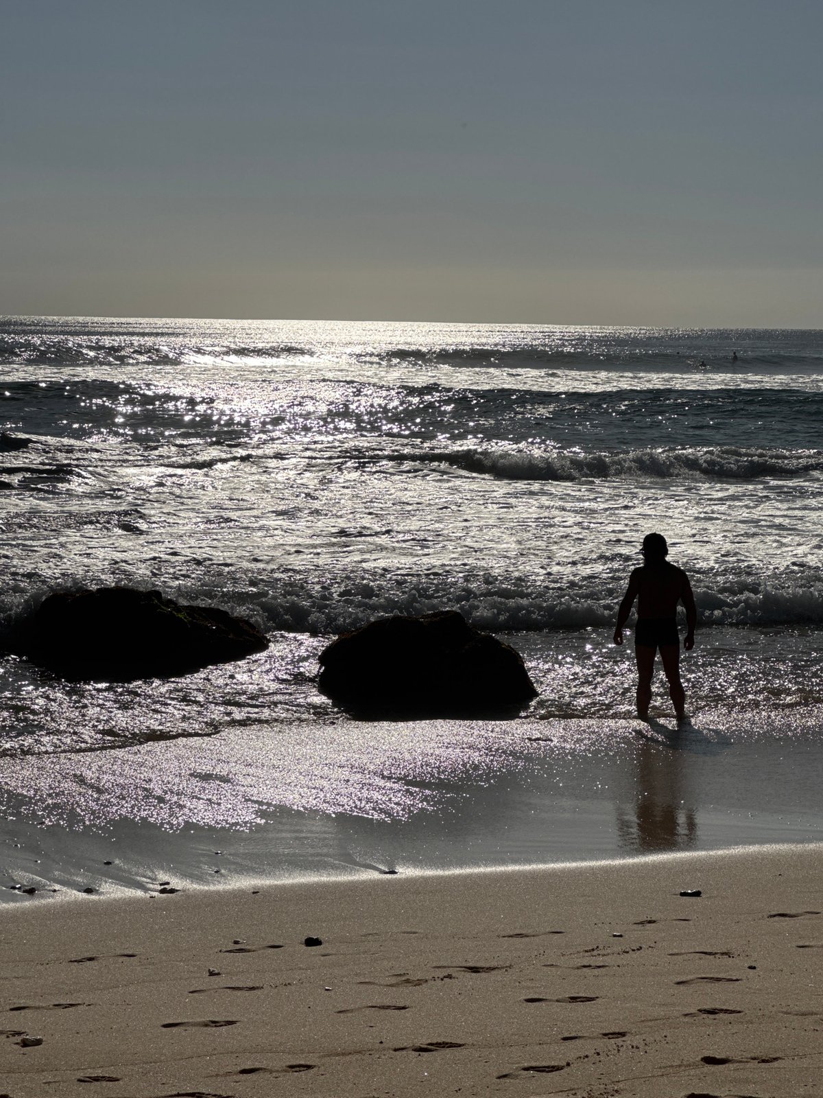 Morning beach life along Kuta Selatan's volcanic shoreline