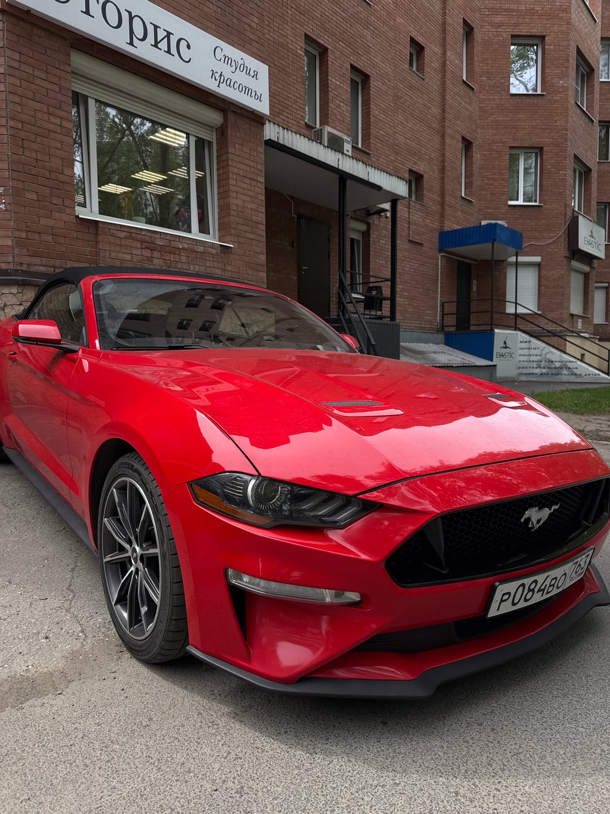 Red Ford Mustang with Russian plates spotted in urban setting