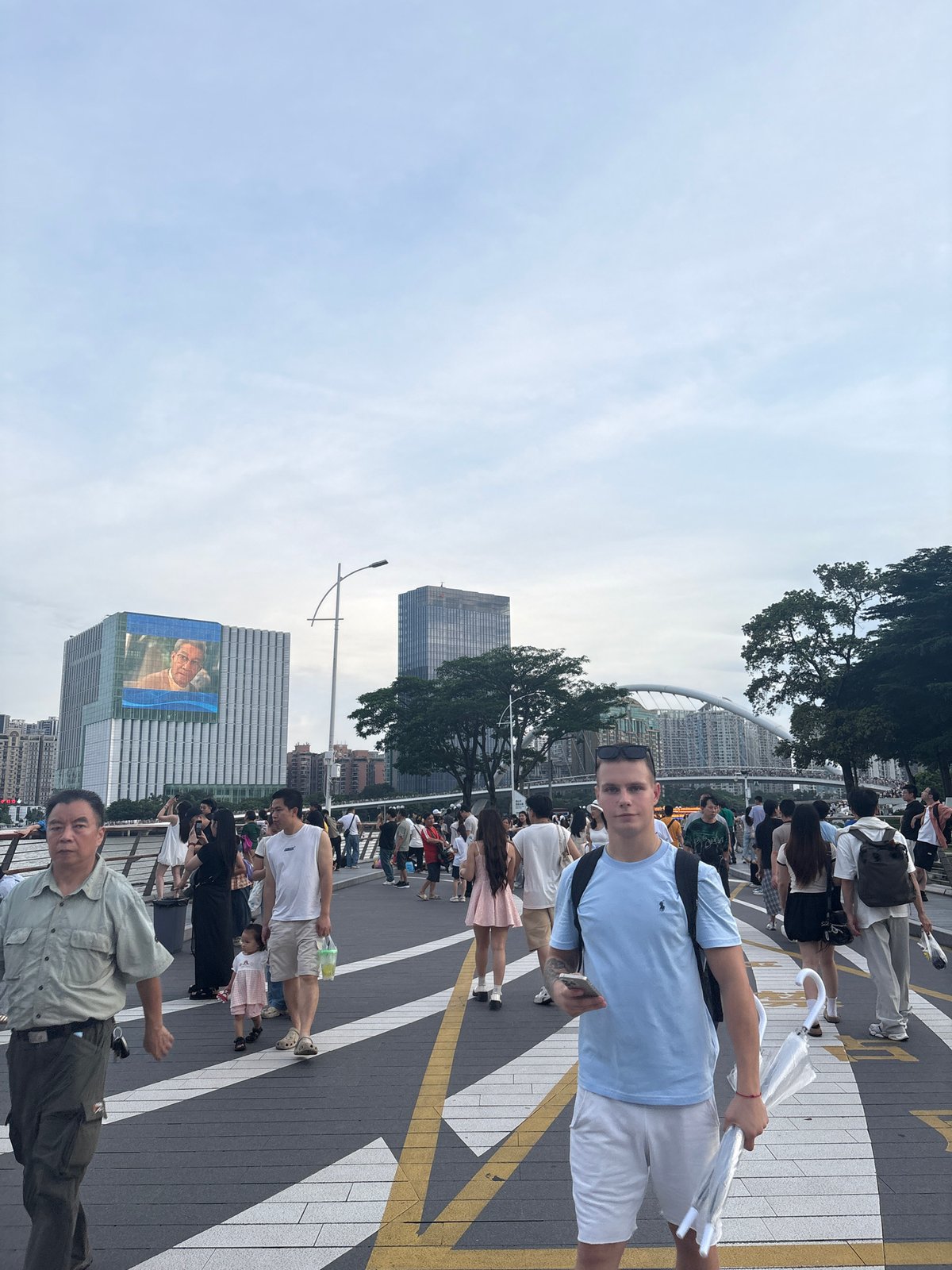 Pearl River promenade buzzing near Canton Tower on a cloudy morning