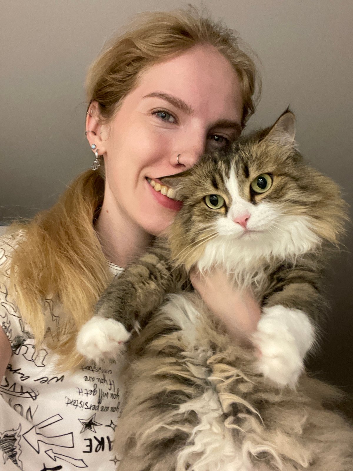 Woman and fluffy cat photographed together in Izhevsk home