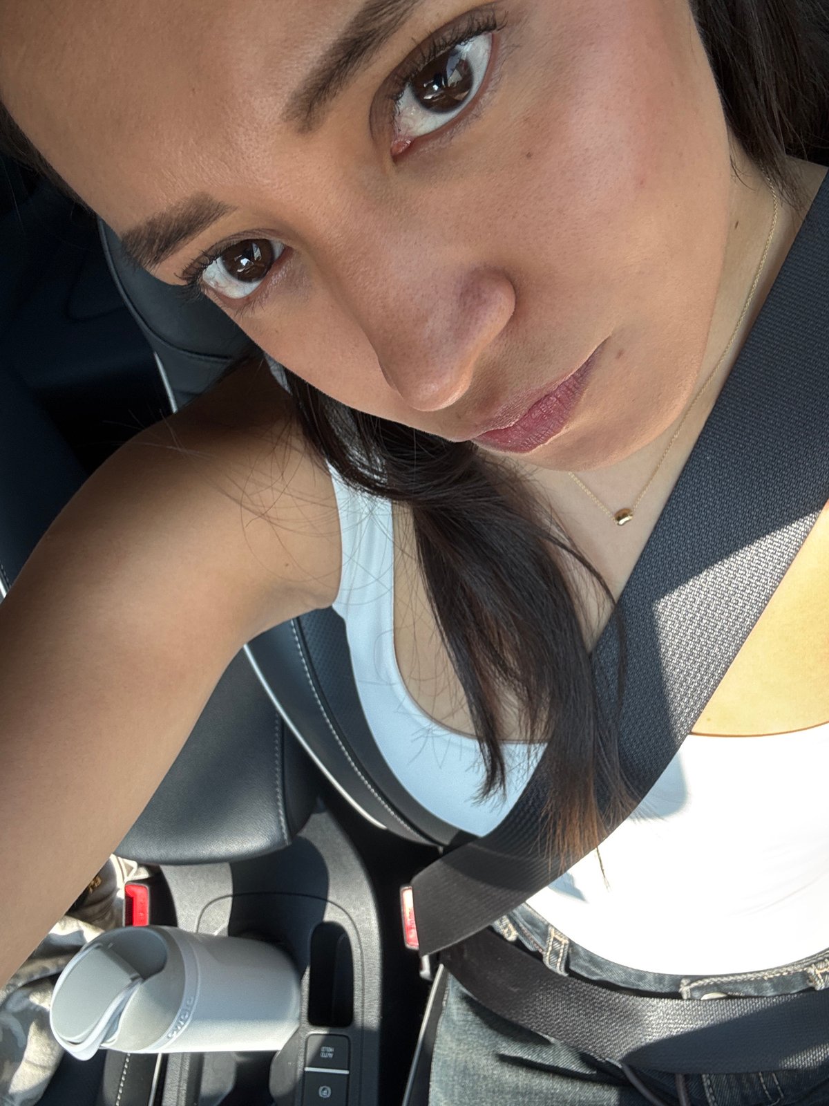 Woman photographed in car during evening travel in Puebla