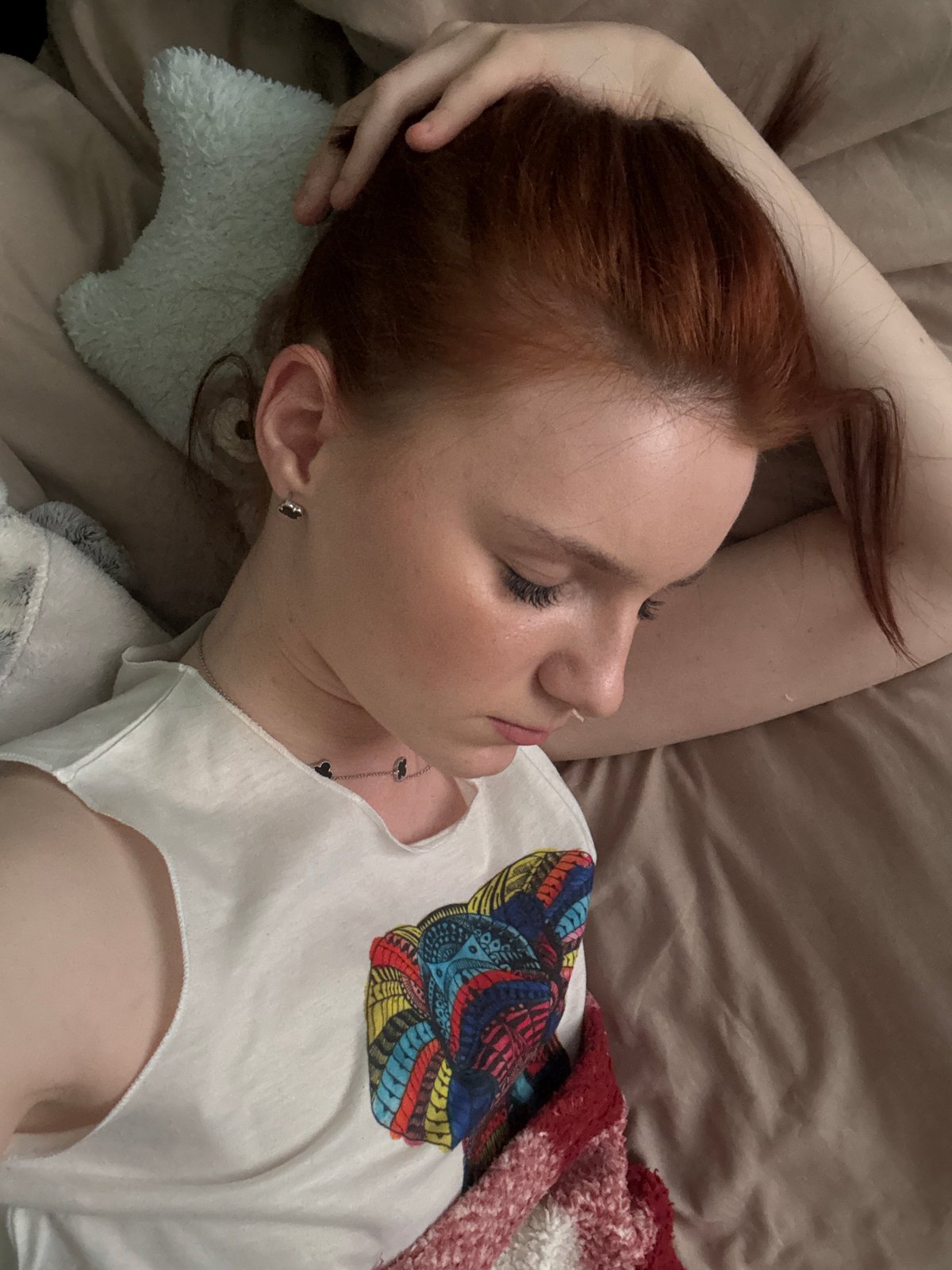 Woman rests on bed with light blue pillow
