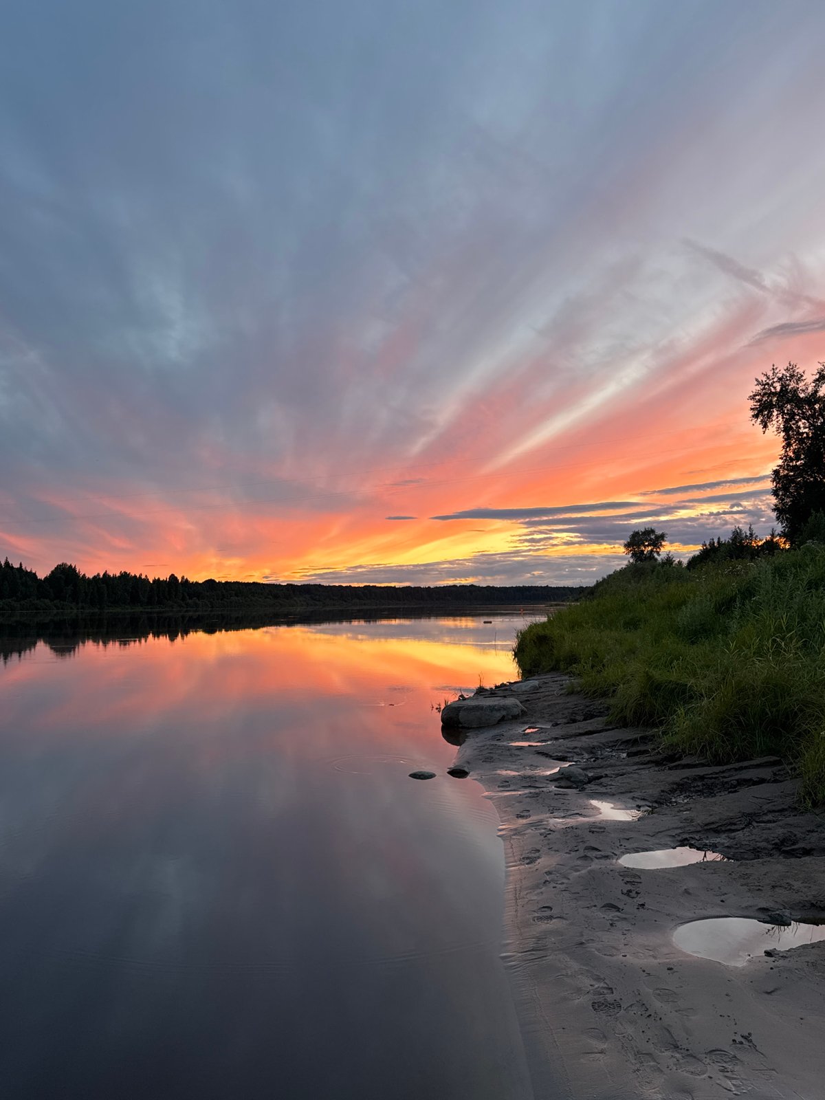 Sunset colors spread across a calm Russian river