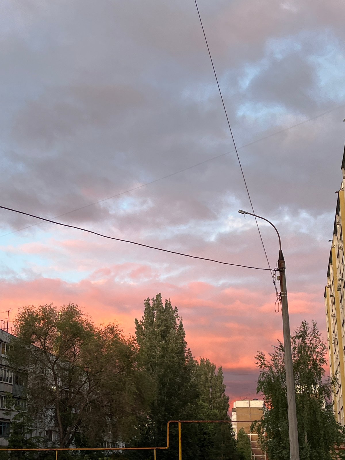 Colorful sunset observed over Novokuybyshevsk street scene