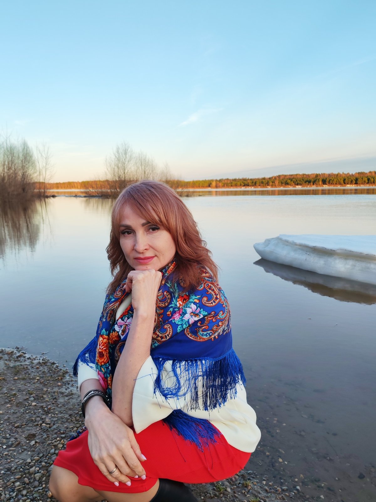 Woman in traditional dress photographed by frozen water in Russia