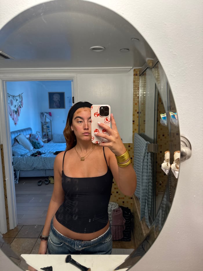 Person takes mirror selfie in Los Angeles bathroom