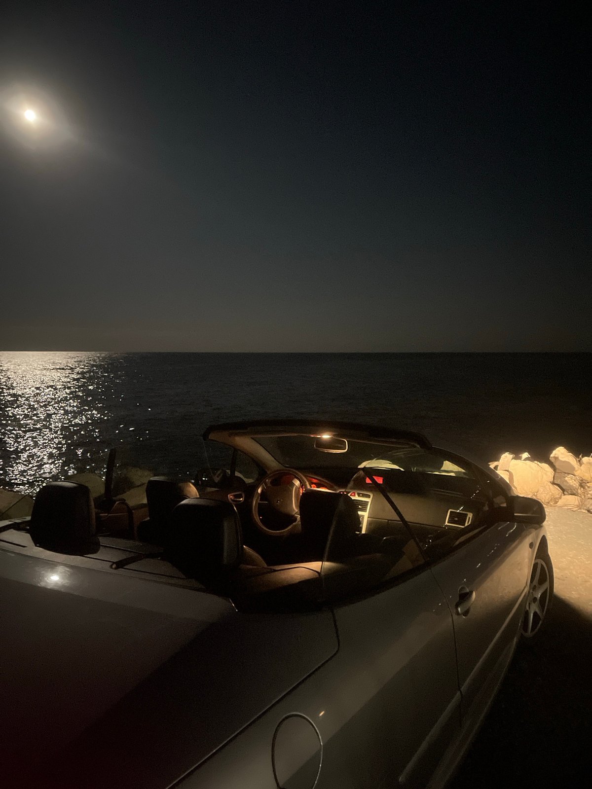 Car parked on Varna cliffs during moonlit evening