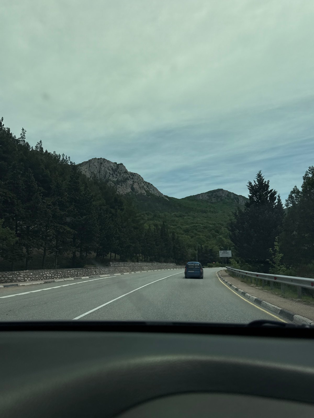 Vehicle travels scenic mountain road in Ukraine