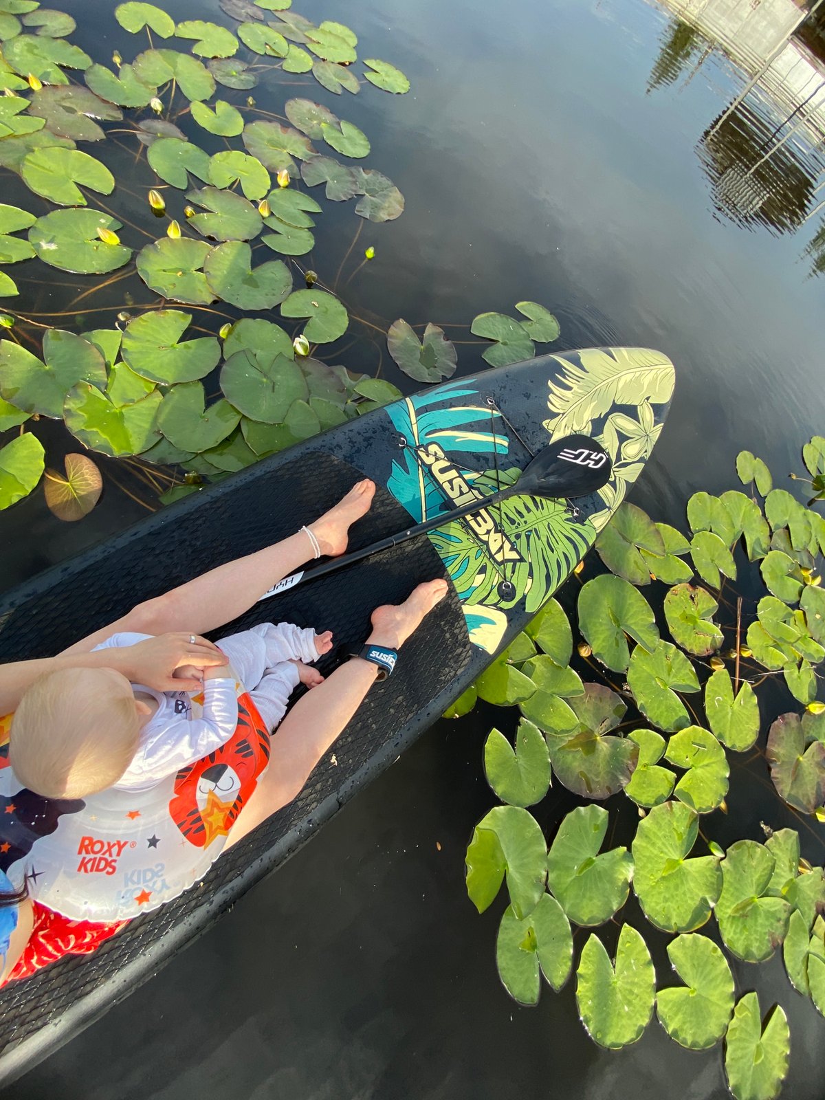 Paddleboarding among lily pads and river traffic near Chaikovsky