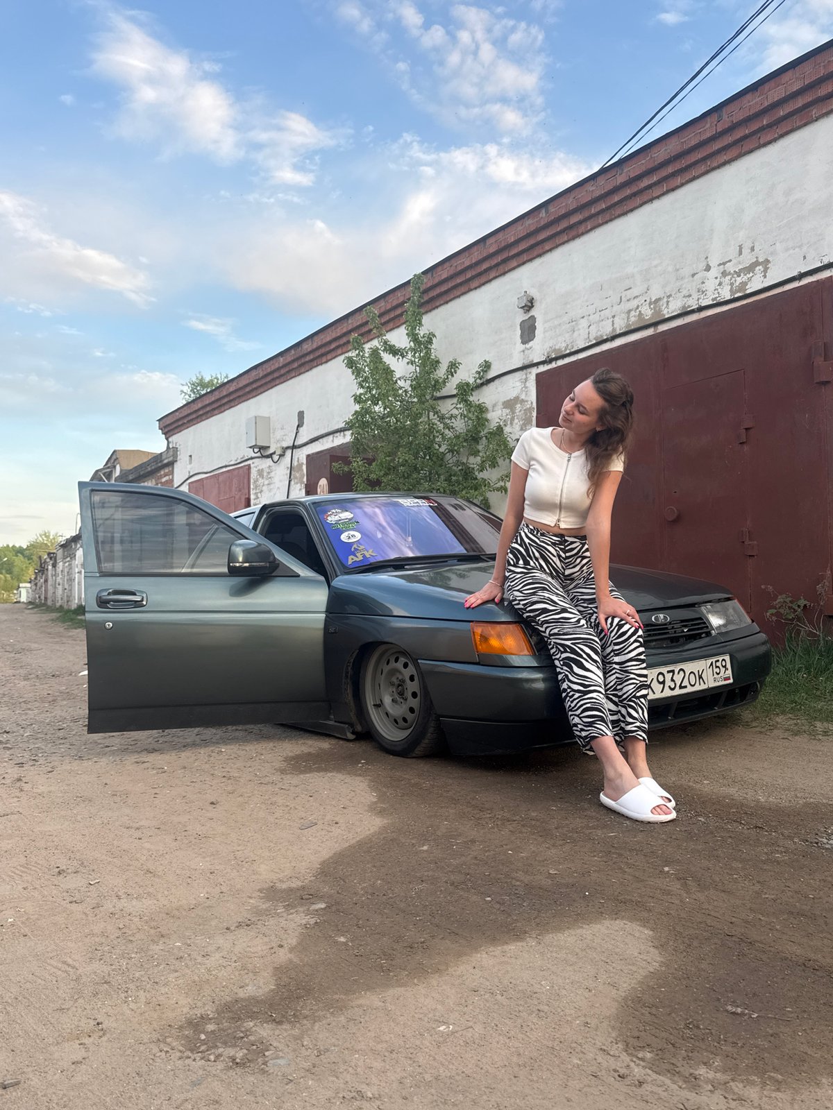 Woman poses on car during photoshoot in Chaikovsky, Russia