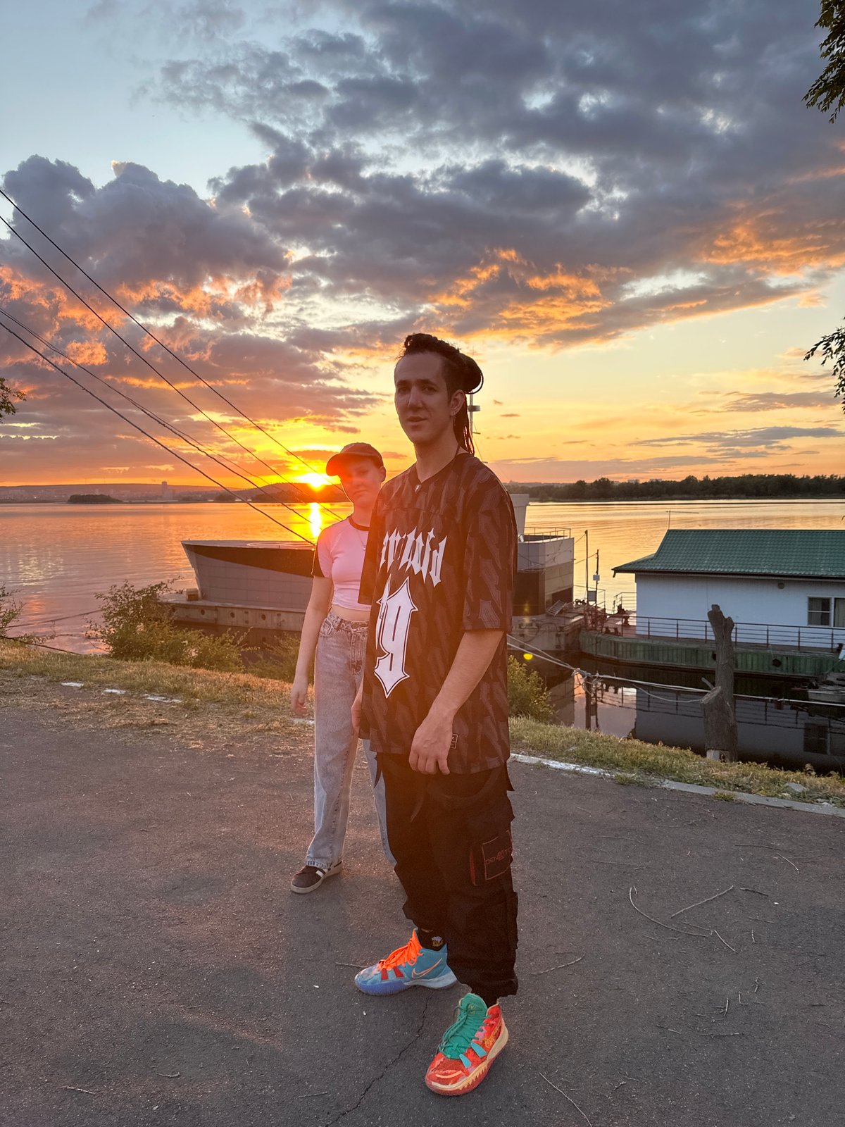 Couple observed by Volga River at sunset in Engels