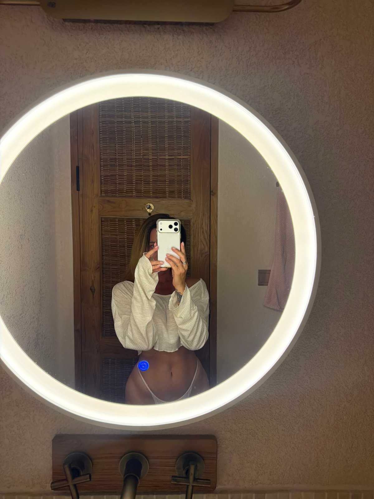 Woman takes bathroom mirror selfies in Mengwi, Indonesia