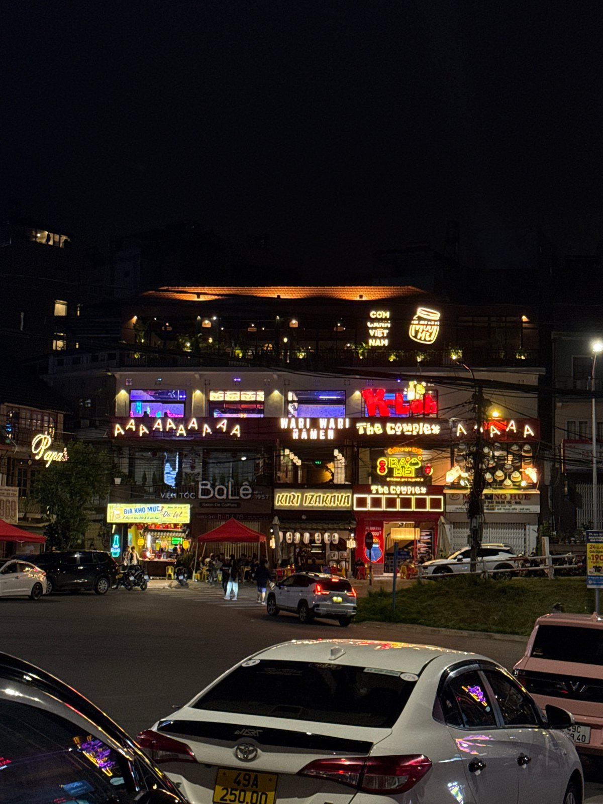 Pink car spotted parked on illuminated Da Lat street