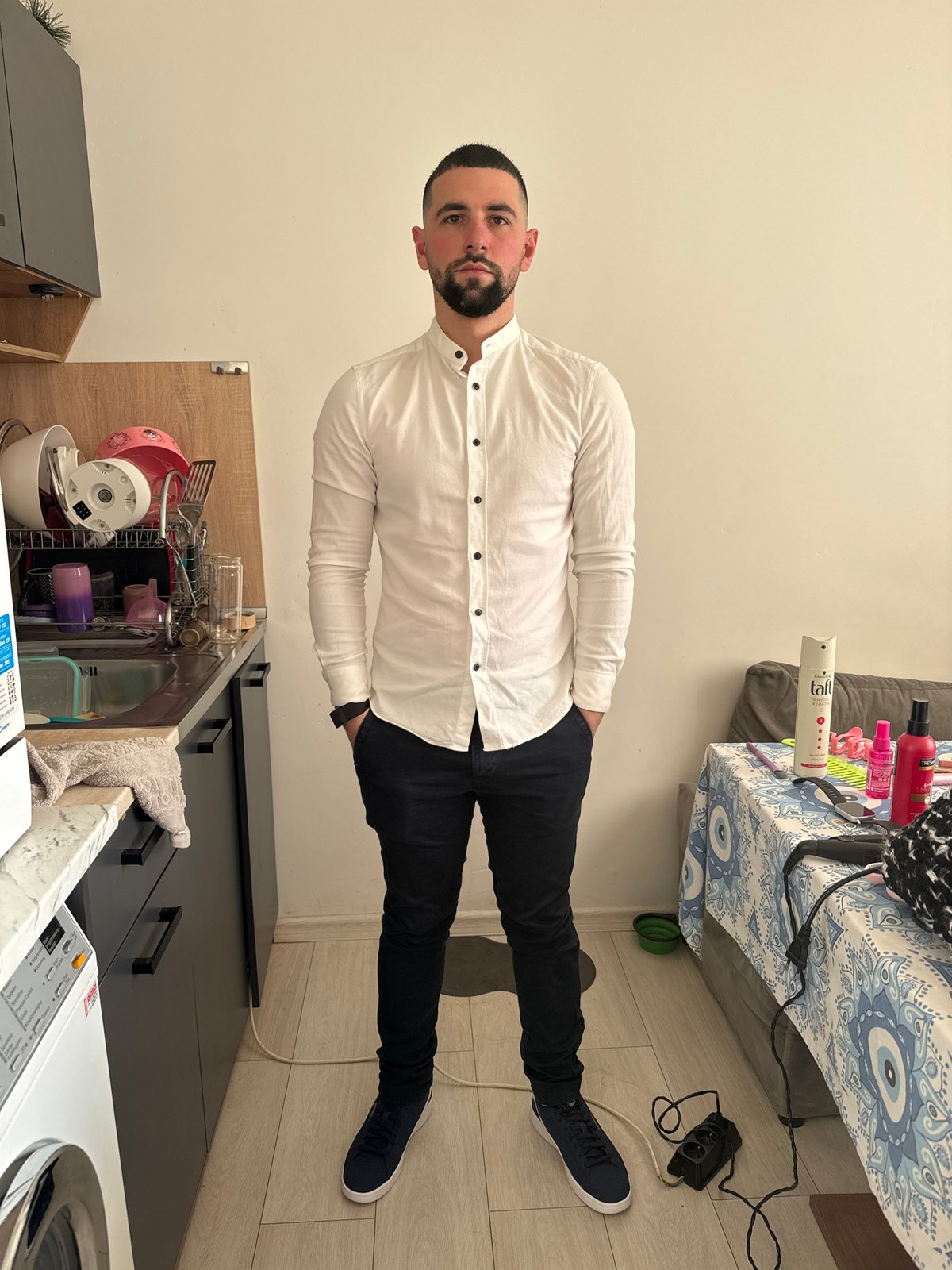Man in white shirt observed standing indoors in Sofia